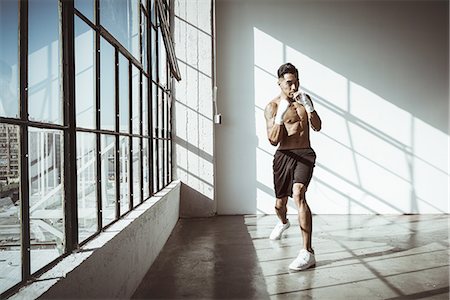 simsearch:614-08879114,k - Full length front view of young man in gym in boxing stance looking at camera Stock Photo - Premium Royalty-Free, Code: 614-08879115