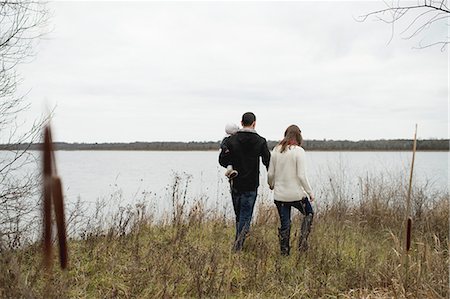 simsearch:6122-07703531,k - Young family walking outdoors, beside lake, rear view Stock Photo - Premium Royalty-Free, Code: 614-08879193