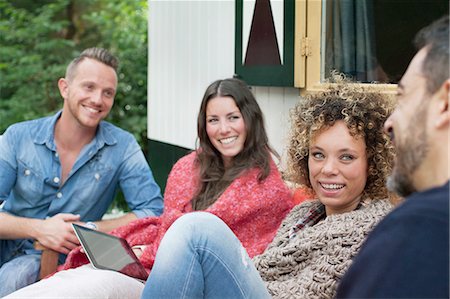 simsearch:614-08879491,k - Four adult friends chatting outside cabin Stock Photo - Premium Royalty-Free, Code: 614-08879513