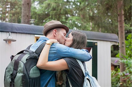 simsearch:614-08879509,k - Romantic couple kissing on cabin porch Fotografie stock - Premium Royalty-Free, Codice: 614-08879524