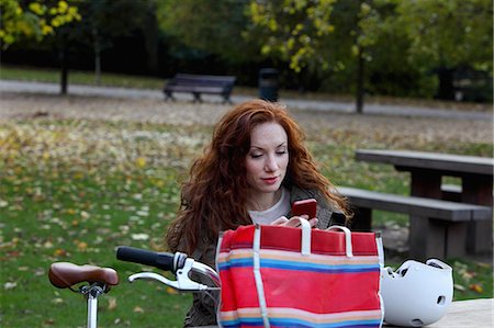 picture autumn london - Woman sitting with bicycle in park Stock Photo - Premium Royalty-Free, Code: 614-08870130