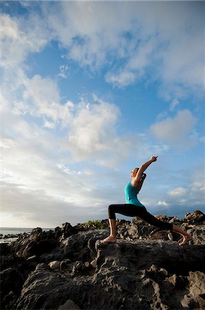 Woman practicing yoga on rock formation Stock Photo - Premium Royalty-Free, Code: 614-08870191