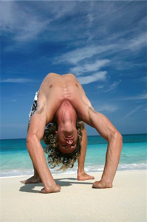 paradise island bahamas beach - Man practicing yoga on tropical beach Stock Photo - Premium Royalty-Free, Code: 614-08870315