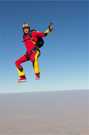 skydiving woman - Woman skydiving over clouds Stock Photo - Premium Royalty-Free, Code: 614-08870330