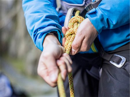 simsearch:649-08969325,k - Rock climber tying rope Photographie de stock - Premium Libres de Droits, Code: 614-08870385