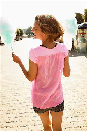 simsearch:614-02258138,k - Woman having cotton candy outdoors Stock Photo - Premium Royalty-Free, Code: 614-08870531