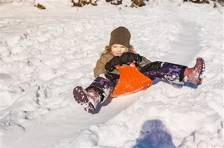 simsearch:614-08126589,k - Smiling girl sledding in snow Photographie de stock - Premium Libres de Droits, Code: 614-08870579