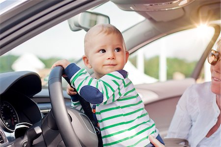 Baby boy playing with steering wheel Stock Photo - Premium Royalty-Free, Code: 614-08870745