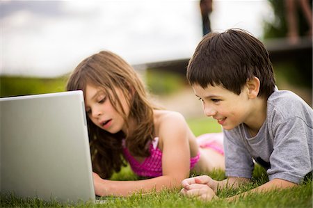 Children using laptop outdoors Stock Photo - Premium Royalty-Free, Code: 614-08870836