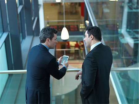 Businessmen talking in office Stock Photo - Premium Royalty-Free, Code: 614-08870987