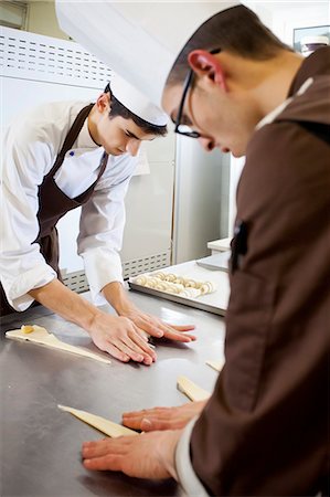 simsearch:614-08871104,k - Bakers shaping dough in kitchen Stock Photo - Premium Royalty-Free, Code: 614-08871083