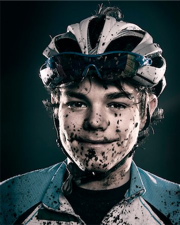 filthy face - Mud splattered cyclist smiling Stock Photo - Premium Royalty-Free, Code: 614-08871144