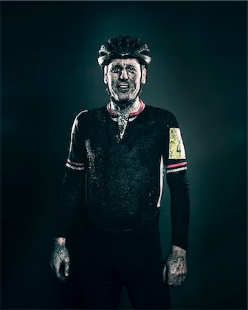 portrait sport - Mud splattered cyclist smiling Stock Photo - Premium Royalty-Free, Code: 614-08871146