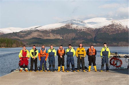 smiling industrial workers group photo - Workers smiling together on salmon farm Stock Photo - Premium Royalty-Free, Code: 614-08871294
