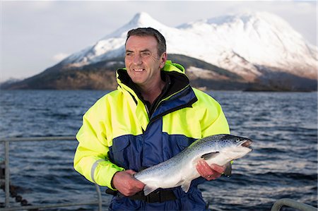 simsearch:649-08004137,k - Worker holding salmon by rural lake Stock Photo - Premium Royalty-Free, Code: 614-08871325