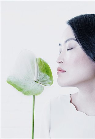 female asian beauty - Woman smelling flower Stock Photo - Premium Royalty-Free, Code: 614-08871335