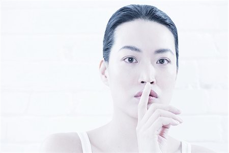simsearch:614-08871355,k - Woman covering lips with finger Stock Photo - Premium Royalty-Free, Code: 614-08871366