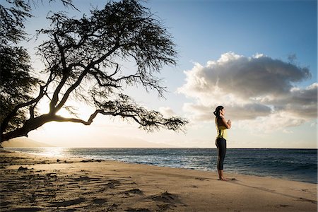 serene people nature - Woman practicing yoga on beach Stock Photo - Premium Royalty-Free, Code: 614-08871427