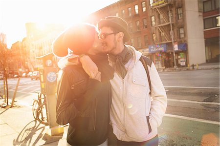 Young couple on urban street kissing Stock Photo - Premium Royalty-Free, Code: 614-08871663