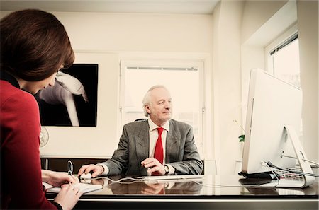 Secretary with senior manager in office Stock Photo - Premium Royalty-Free, Code: 614-08871757