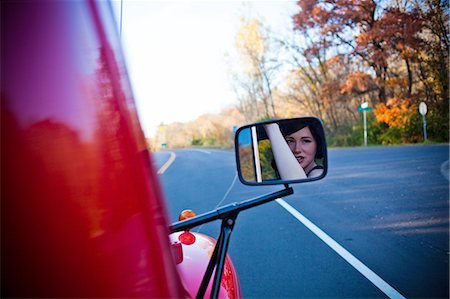 Reflection of woman in wing mirror Stock Photo - Premium Royalty-Free, Code: 614-08872029