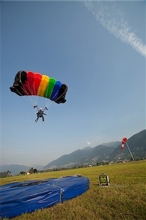 Skydiver with parachute over Locarno, Tessin, Switzerland Stock Photo - Premium Royalty-Free, Code: 614-08872089