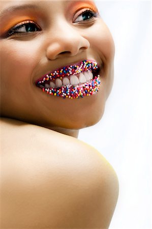 simsearch:614-08872379,k - Portrait of young woman with lips covered with sprinkles Foto de stock - Royalty Free Premium, Número: 614-08872229
