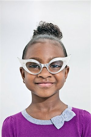 simsearch:614-08872581,k - Head and shoulders of girl wearing funny glasses Fotografie stock - Premium Royalty-Free, Codice: 614-08872589
