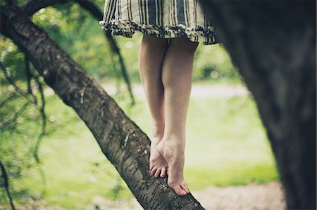 simsearch:614-02343903,k - Woman tiptoeing on branch of tree Stock Photo - Premium Royalty-Free, Code: 614-08872694