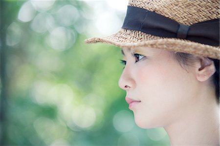 simsearch:614-02838620,k - Young woman wearing straw hat, portrait Stock Photo - Premium Royalty-Free, Code: 614-08872758