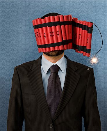 sparking dynamite - Businessman wrapped in dynamite Stock Photo - Premium Royalty-Free, Code: 614-08872845