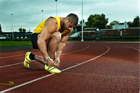 simsearch:614-08873104,k - Sprinter tying shoelace on race track Foto de stock - Sin royalties Premium, Código: 614-08873095