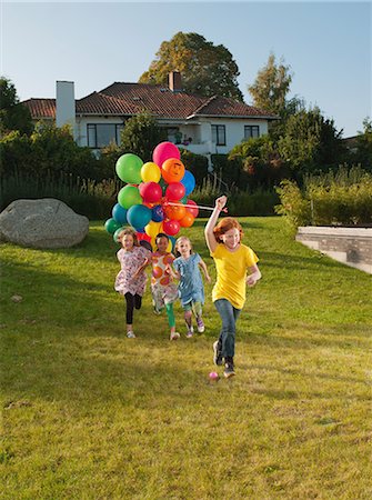 simsearch:614-08873144,k - Girls running across lawn with multicoloured balloons Photographie de stock - Premium Libres de Droits, Code: 614-08873149