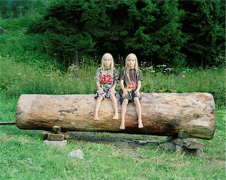 Twin brothers on a log, Nowica, Poland Stock Photo - Premium Royalty-Free, Code: 614-08873224