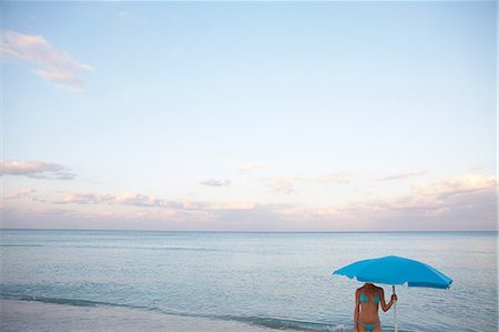 simsearch:614-06311878,k - Woman under beach umbrella Photographie de stock - Premium Libres de Droits, Code: 614-08873233