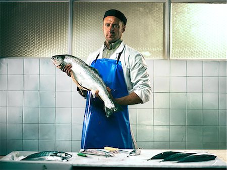 Fishmonger holding a salmon Stock Photo - Premium Royalty-Free, Code: 614-08873470