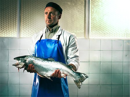 Fishmonger holding a salmon Stock Photo - Premium Royalty-Free, Code: 614-08873471