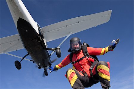 parachute over the blue sky - Woman freefly skydiving from airplane Stock Photo - Premium Royalty-Free, Code: 614-08873489