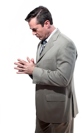 smart businessman white background - Serious looking businessman with hands together Stock Photo - Premium Royalty-Free, Code: 614-08873533