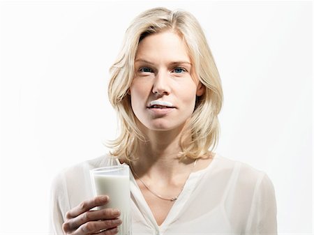 embarrassing - Mid adult woman with milk moustache, studio shot Stock Photo - Premium Royalty-Free, Code: 614-08873558