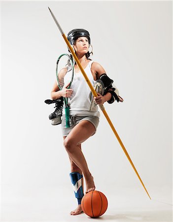 Young woman holding sports equipment against white background Foto de stock - Sin royalties Premium, Código: 614-08873584