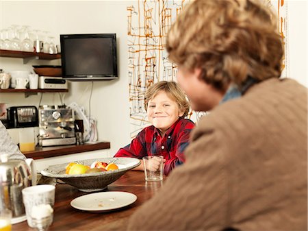 simsearch:614-08873625,k - Teenage boy and brother sitting at kitchen table Stock Photo - Premium Royalty-Free, Code: 614-08873614