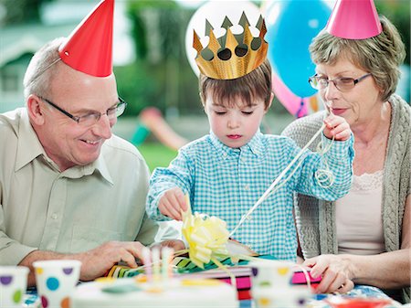 Boy with grandparents at birthday party Stock Photo - Premium Royalty-Free, Code: 614-08873780