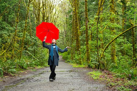 red scarf woman - Woman on forest path with red umbrella Stock Photo - Premium Royalty-Free, Code: 614-08873870