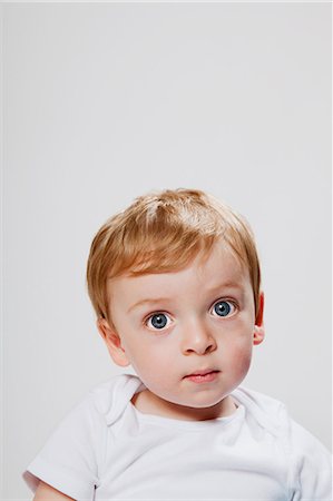 Baby boy looking at camera Stock Photo - Premium Royalty-Free, Code: 614-08873873