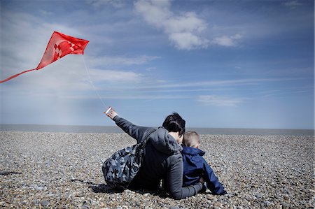 Mother and son on pebble beach with kite Stock Photo - Premium Royalty-Free, Code: 614-08873896