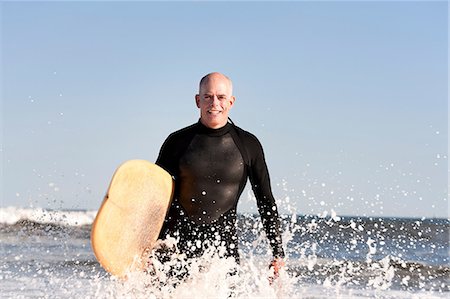 simsearch:614-05522909,k - Surfer in sea with surfboard Fotografie stock - Premium Royalty-Free, Codice: 614-08873928