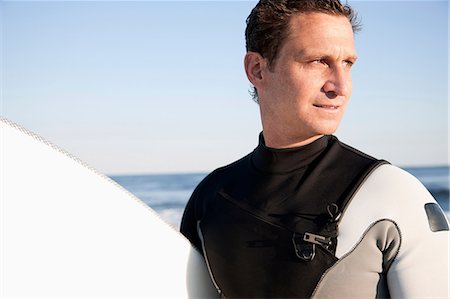 simsearch:649-07437735,k - Surfer looking away, portrait Photographie de stock - Premium Libres de Droits, Code: 614-08873934