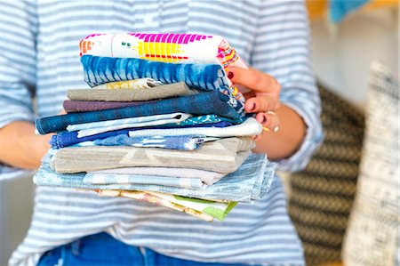 samples supermarket - Mid section of female interior designer holding stack of textile swatches in retail studio Stock Photo - Premium Royalty-Free, Code: 614-08884378