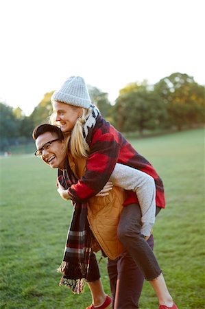 simsearch:649-07521104,k - Man giving girlfriend a piggyback in park Stock Photo - Premium Royalty-Free, Code: 614-08884456